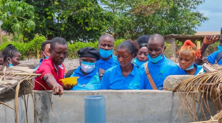 Trainees looking into a concrete fish tank